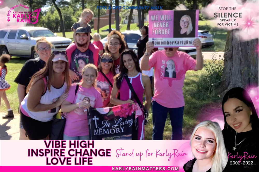 Karly Rain graphic from the FOTS and OPD Community Walk: supporters in pink holding a We Will Never Forget sign and an In Loving Memory banner, with photos of Karly Rain, 2002 to 2022, and the words Vibe High, Inspire Change, Love Life, Stand up for Karly Rain, and Stop the Silence, Speak Up for Victims.