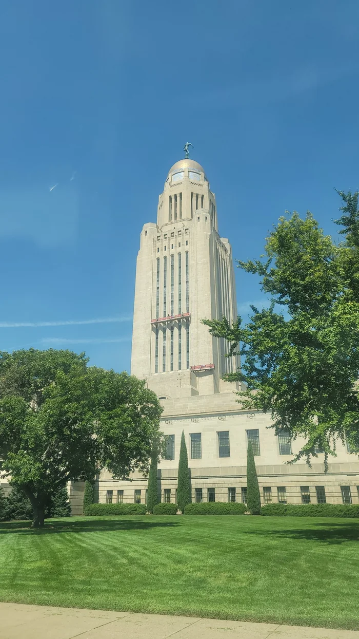 The Nebraska State Capitol in Lincoln under a blue sky.