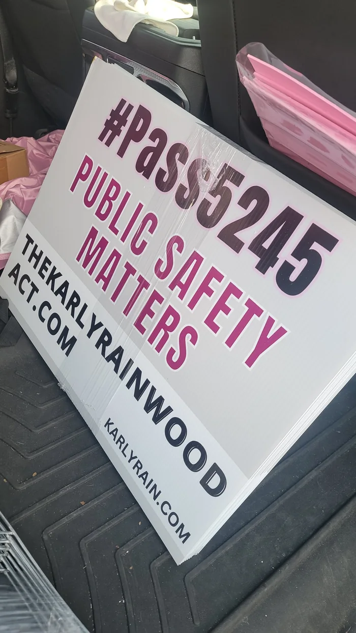 A stack of #Pass5245 Public Safety Matters yard signs.